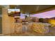 Outdoor kitchen features a built-in grill, beautiful stone accents, countertop seating and a wall-mounted television at 10455 E Thatcher Ave, Mesa, AZ 85212