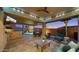 Inviting covered patio featuring an outdoor kitchen, TV, comfortable seating, and scenic twilight views at 10455 E Thatcher Ave, Mesa, AZ 85212