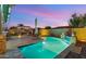 Sparkling pool features a rock waterfall feature, lounge chairs and a manicured backyard at 10455 E Thatcher Ave, Mesa, AZ 85212