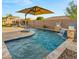 Sparkling pool with tranquil water feature and umbrella providing a refreshing and relaxing backyard oasis at 10455 E Thatcher Ave, Mesa, AZ 85212