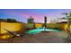 Inviting pool features stone accents, a rock waterfall feature and lounge chairs at 10455 E Thatcher Ave, Mesa, AZ 85212