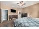 Well-lit main bedroom featuring neutral walls, dark furniture, and connecting bathroom and closet doors for convenience at 11130 E Shepperd Ave, Mesa, AZ 85212