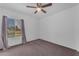 Bedroom featuring carpet, ceiling fan, and natural light from window at 11604 N 58Th Ave, Glendale, AZ 85304