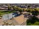 Aerial view of community park with basketball and volleyball courts, set amongst mature trees at 11737 N 143Rd Dr, Surprise, AZ 85379