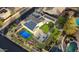 Stunning aerial view of a home with solar panels, a pickleball court, a pool and lush landscaping at 11737 N 143Rd Dr, Surprise, AZ 85379