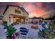 Inviting backyard with fire pit and outdoor seating, perfect for entertaining under colorful sunset skies at 11737 N 143Rd Dr, Surprise, AZ 85379