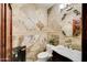 Chic half-bathroom with patterned tile walls, a decorative mirror, and modern fixtures, maximizing style in a small space at 11737 N 143Rd Dr, Surprise, AZ 85379