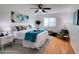 Bright bedroom featuring modern decor, including an accent chair and bedside table at 11737 N 143Rd Dr, Surprise, AZ 85379