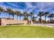 The Copper Canyon Ranch community entrance is framed by towering palm trees and lush landscaping at 11737 N 143Rd Dr, Surprise, AZ 85379