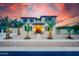 Beautiful home exterior featuring decorative stone, lush landscaping, and a welcoming entrance at 11737 N 143Rd Dr, Surprise, AZ 85379