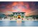 Stunning two-story home with well-manicured front yard and vibrant sunset sky at 11737 N 143Rd Dr, Surprise, AZ 85379