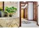 Elegant hallway with marble floors, wood trim, and decorative plant at 11737 N 143Rd Dr, Surprise, AZ 85379
