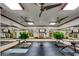 Large home gym with rubber flooring, multiple ceiling fans, and mirrored walls at 11737 N 143Rd Dr, Surprise, AZ 85379
