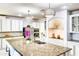 Elegant kitchen with granite counters, white cabinetry, and stainless steel appliances at 11737 N 143Rd Dr, Surprise, AZ 85379