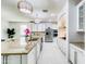 Open-concept kitchen with stainless steel appliances, granite countertops, and stylish lighting at 11737 N 143Rd Dr, Surprise, AZ 85379