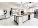 Open kitchen featuring a large island, stainless steel appliances, and sliding glass doors at 11737 N 143Rd Dr, Surprise, AZ 85379