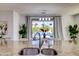 Features a kitchen with granite countertops, stainless steel sink, a window to the backyard, and modern lighting at 11737 N 143Rd Dr, Surprise, AZ 85379