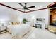 Serene main bedroom with a ceiling fan, marble floors, and a luxurious vanity area, creating a relaxing retreat at 11737 N 143Rd Dr, Surprise, AZ 85379