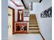 Beautiful staircase with carpeted steps and custom built-in display shelving at 11737 N 143Rd Dr, Surprise, AZ 85379