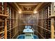 Spacious wine cellar with custom wooden racks, designed to store and showcase a vast collection of fine wines at 11737 N 143Rd Dr, Surprise, AZ 85379