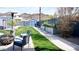 Serene backyard with lush greenery, garden beds, seating area, and a charming blue shed at 1207 E Alice Ave, Phoenix, AZ 85020