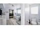 Sleek bathroom with a freestanding tub, glass-enclosed shower, and modern fixtures throughout at 1207 E Alice Ave, Phoenix, AZ 85020