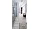 Modern bathroom with glass shower, tile floor, and adjacent walk-in closet with ample storage at 1207 E Alice Ave, Phoenix, AZ 85020