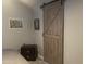 Bedroom with a sliding barn door and a dresser; painting hanging above bedside table at 1207 E Alice Ave, Phoenix, AZ 85020