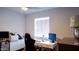 Bright bedroom featuring a modern desk, gaming chair, and ample natural light from the window at 1207 E Alice Ave, Phoenix, AZ 85020