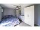 Cozy bedroom with a plush bed, built-in wardrobe, and ceiling fan for added comfort at 1207 E Alice Ave, Phoenix, AZ 85020