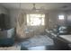 Cozy living room with hardwood floors, a hanging swing chair, and lots of natural light at 1207 E Alice Ave, Phoenix, AZ 85020