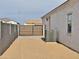 View of side yard area with a black metal gate, and an air conditioning unit at 1586 N Himosa Dr, Casa Grande, AZ 85122