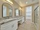 Ensuite bathroom with dual sinks, granite countertops, modern lighting, and glass shower doors at 1586 N Himosa Dr, Casa Grande, AZ 85122
