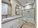 Beautiful bathroom featuring double sinks with granite countertop and a glass shower at 1586 N Himosa Dr, Casa Grande, AZ 85122