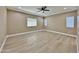 Spacious bedroom with tray ceiling, recessed lighting, a ceiling fan, and three windows at 1586 N Himosa Dr, Casa Grande, AZ 85122