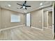 Bright bedroom features a ceiling fan, a window with blinds, neutral walls, and beige tiling at 1586 N Himosa Dr, Casa Grande, AZ 85122