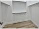 Walk-in closet featuring neutral toned flooring and white shelving and railing for storage at 1586 N Himosa Dr, Casa Grande, AZ 85122