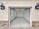Spacious two car garage features black lantern lights, brick accents, and a white interior at 1586 N Himosa Dr, Casa Grande, AZ 85122