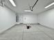 Spacious two car garage with a garage door, concrete flooring, and white walls at 1586 N Himosa Dr, Casa Grande, AZ 85122