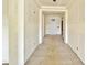 Inviting hallway features beige tiled flooring, leading to the front door, creating an open and airy feel at 1586 N Himosa Dr, Casa Grande, AZ 85122