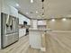 Modern kitchen featuring stainless steel refrigerator and island with pendant lighting at 1586 N Himosa Dr, Casa Grande, AZ 85122