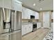 Contemporary kitchen with stainless steel appliances, granite countertops and white cabinetry at 1586 N Himosa Dr, Casa Grande, AZ 85122