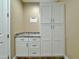 Functional laundry room featuring ample storage cabinets and granite countertops at 1586 N Himosa Dr, Casa Grande, AZ 85122