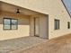Covered patio area with a ceiling fan, neutral walls, and tan brick flooring at 1586 N Himosa Dr, Casa Grande, AZ 85122