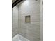 This shower features beautiful tile and a built in nook for storage at 1586 N Himosa Dr, Casa Grande, AZ 85122