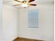 A well lit bedroom with a fan, a window, and neutral colored carpet at 1737 W Hopi Dr, Coolidge, AZ 85128