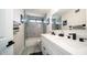 Modern bathroom features double vanity, contemporary fixtures, and a tiled shower-tub combination at 17414 N 56Th Way, Scottsdale, AZ 85254