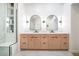 Bathroom with dual vanity, custom cabinets, marble countertops, and a glass-enclosed shower at 17414 N 56Th Way, Scottsdale, AZ 85254