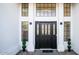 Elegant front entrance featuring a stylish black door with decorative glass panels at 17414 N 56Th Way, Scottsdale, AZ 85254