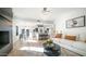 Open-concept living space features a sleek black fireplace, modern decor, and a kitchen view at 17414 N 56Th Way, Scottsdale, AZ 85254